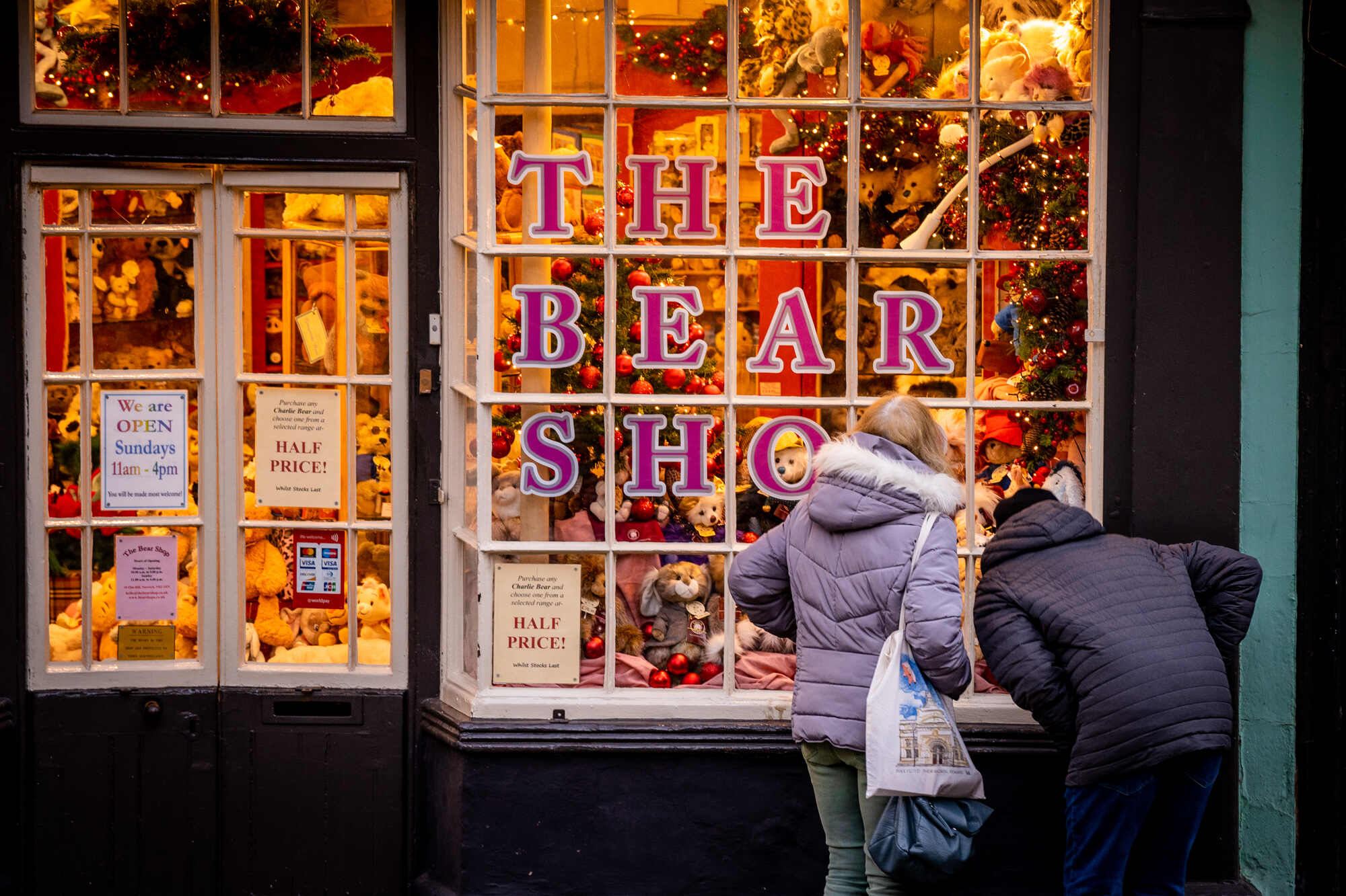 Image showing two people looking at shop window with the words bear shop written on the front