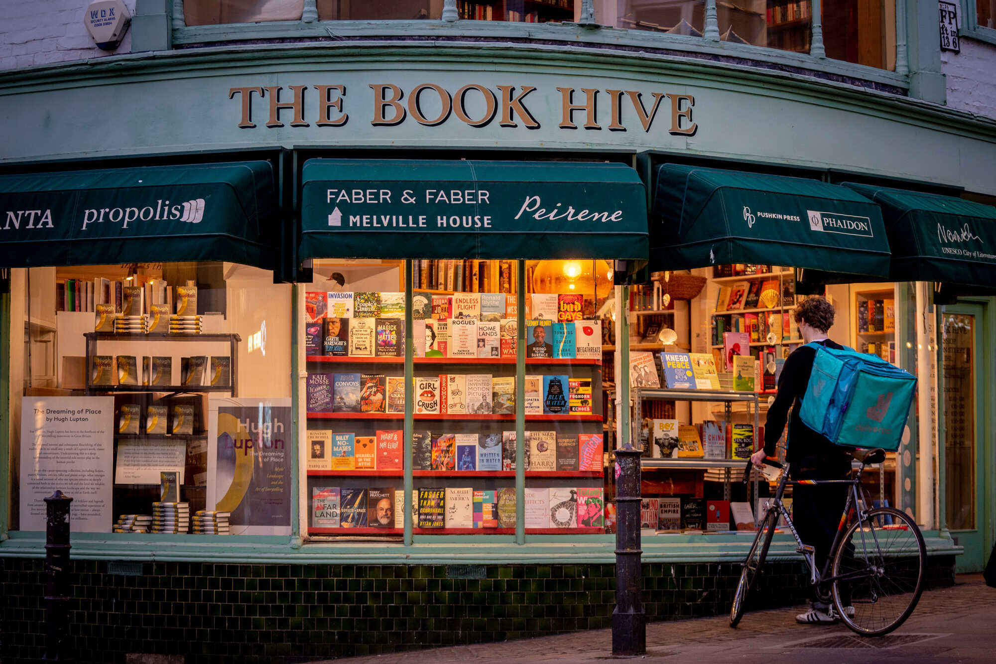Image showing person with bicycle looking at book shop window
